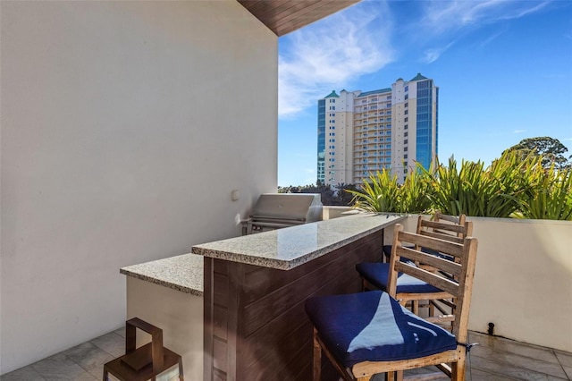 view of patio with an outdoor kitchen, area for grilling, and an outdoor bar