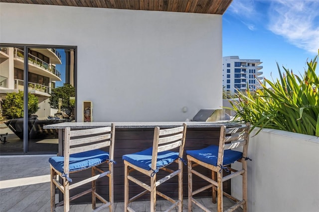 balcony featuring exterior kitchen and exterior bar