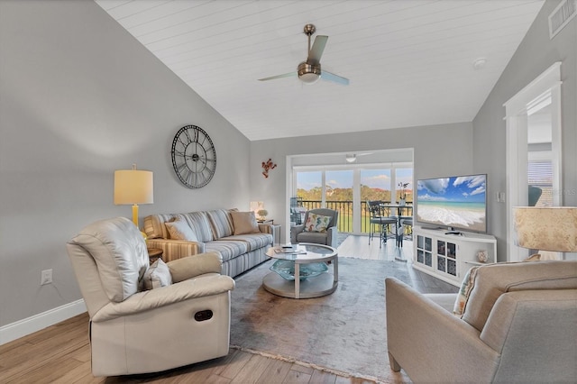 living room with vaulted ceiling, ceiling fan, and light wood-type flooring