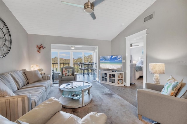 living room featuring ceiling fan, vaulted ceiling, and light hardwood / wood-style flooring