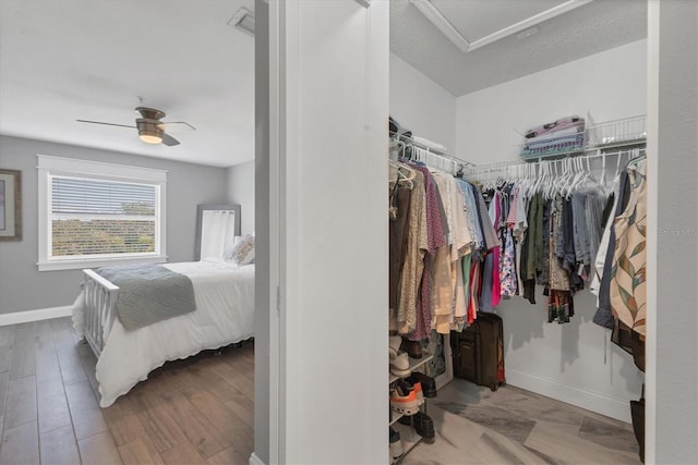 bedroom with light hardwood / wood-style flooring, a closet, and ceiling fan