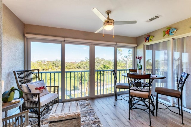 sunroom / solarium featuring ceiling fan