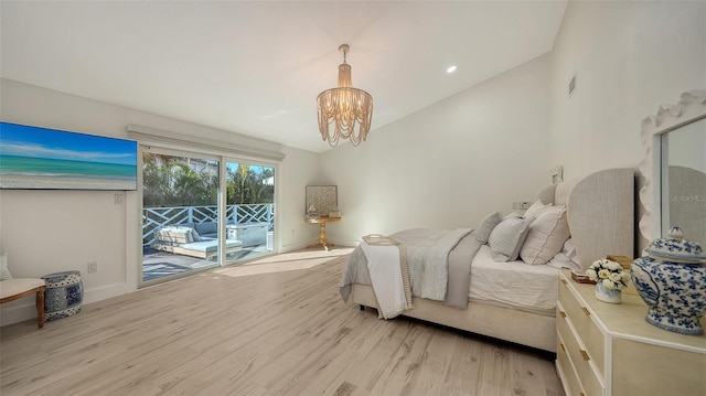 bedroom with lofted ceiling, a chandelier, access to exterior, and light hardwood / wood-style floors