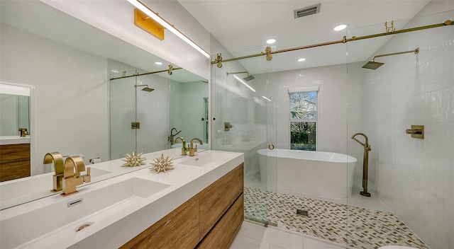 bathroom with tile patterned floors, vanity, and independent shower and bath