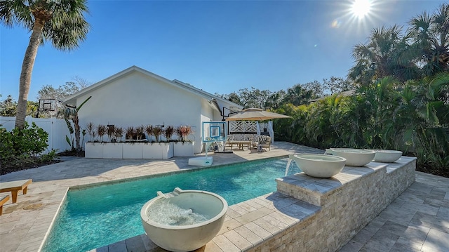 view of swimming pool featuring pool water feature and a patio area