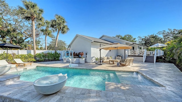 view of pool with outdoor lounge area, a deck, and a patio area