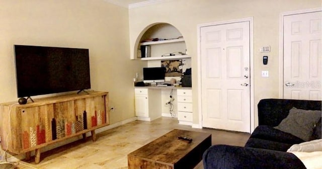 living room featuring crown molding and built in features