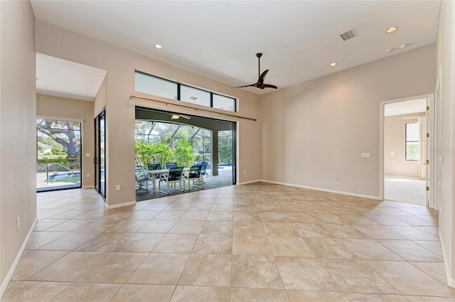 unfurnished room with ceiling fan and light tile patterned floors