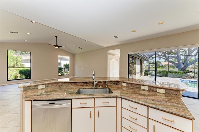 kitchen featuring stainless steel dishwasher, light stone countertops, sink, and white cabinets