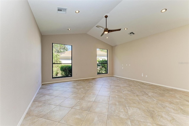 spare room with lofted ceiling, light tile patterned floors, and ceiling fan