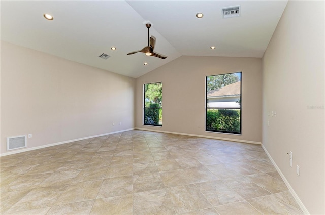 spare room with vaulted ceiling, a healthy amount of sunlight, and ceiling fan