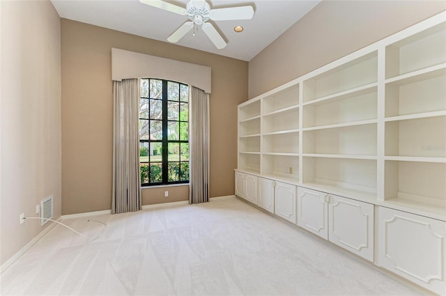 empty room with ceiling fan and light colored carpet