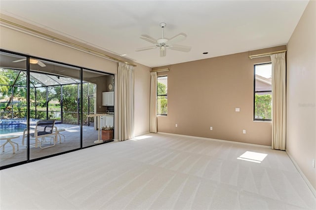 carpeted empty room featuring ceiling fan