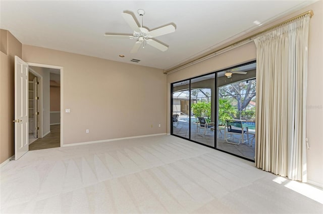 unfurnished room with light colored carpet and ceiling fan