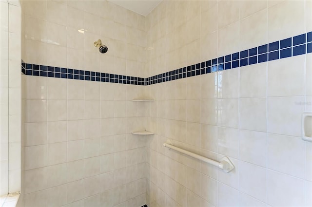 bathroom with tiled shower