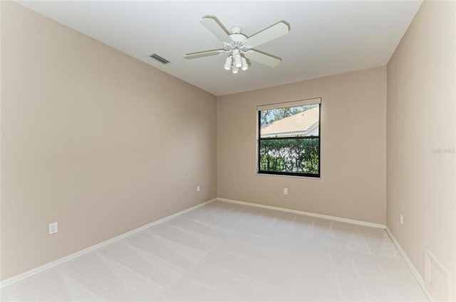 spare room featuring ceiling fan and light colored carpet