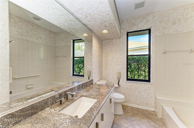 full bathroom with tile patterned floors, vanity, toilet, and tiled shower / bath