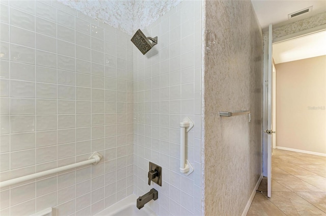 bathroom featuring tiled shower / bath and tile patterned flooring