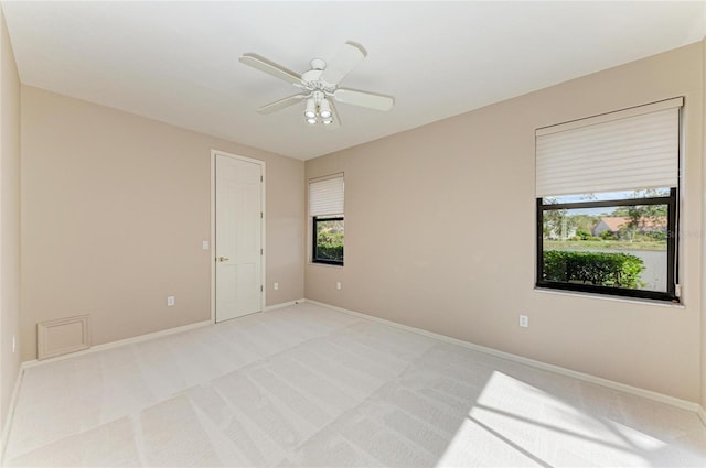 unfurnished room with ceiling fan and light colored carpet