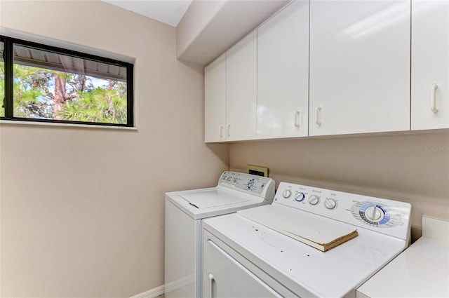 washroom featuring cabinets and washing machine and dryer