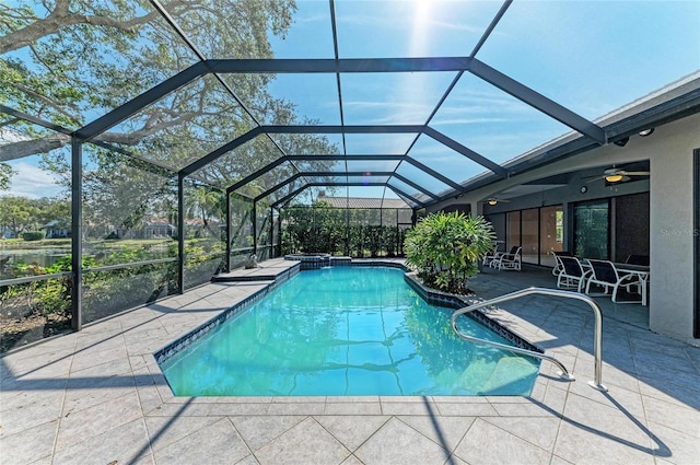 view of pool featuring glass enclosure and a patio area