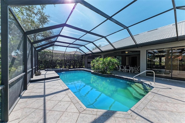 view of swimming pool featuring a lanai and a patio area