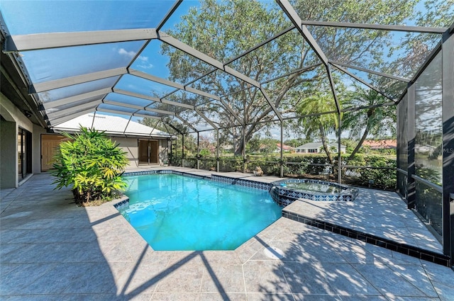 view of swimming pool with an in ground hot tub, a lanai, and a patio