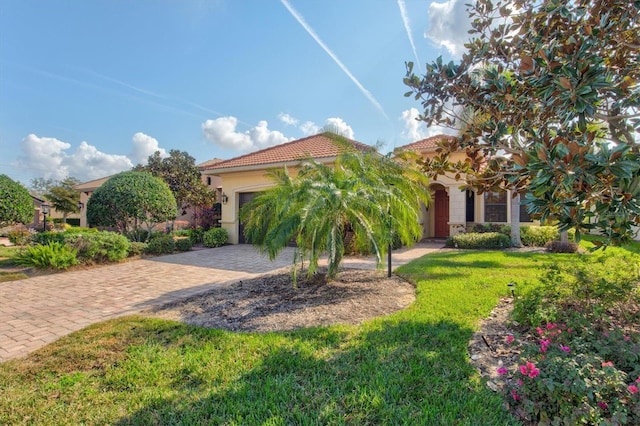 mediterranean / spanish-style home with a garage and a front yard