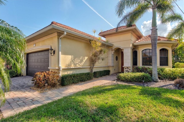 mediterranean / spanish-style home with a garage and a front yard