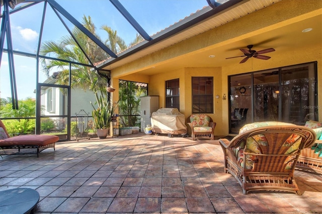 view of patio featuring a lanai and ceiling fan