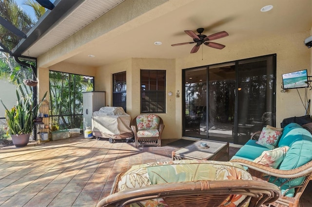 view of patio / terrace with ceiling fan and an outdoor living space