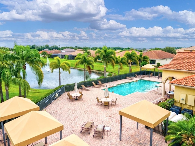 view of pool with a water view, a patio area, and a gazebo