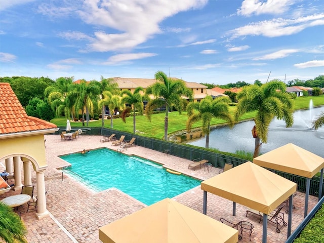 view of pool featuring a patio and a water view