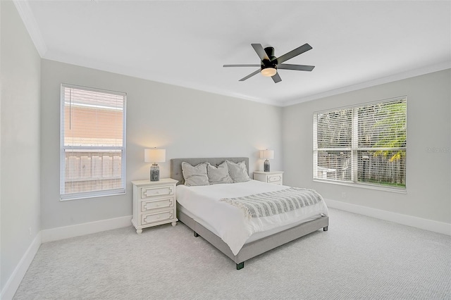 carpeted bedroom featuring multiple windows, ornamental molding, and ceiling fan