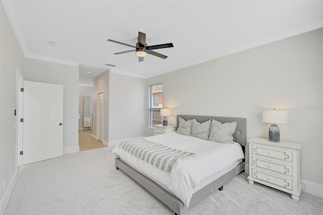 bedroom with ensuite bath, ceiling fan, ornamental molding, light colored carpet, and a closet