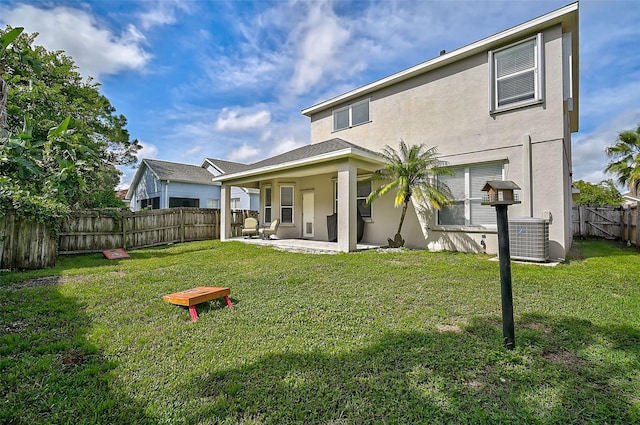 rear view of property with central AC unit, a lawn, and a patio