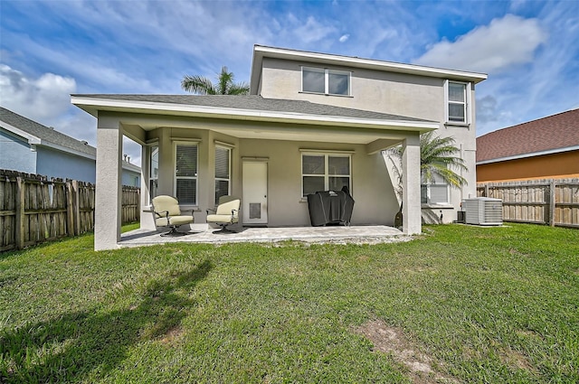 back of house featuring a yard, a patio, and central air condition unit