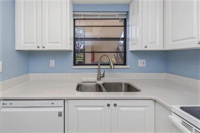 kitchen with white cabinetry, white dishwasher, and sink