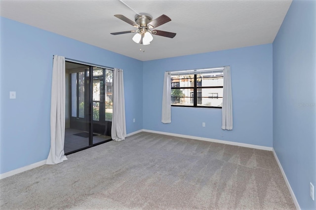 carpeted empty room with ceiling fan