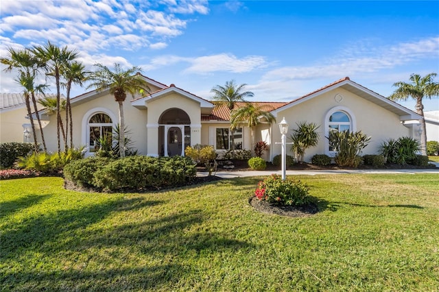 mediterranean / spanish house with a front yard