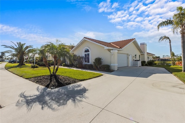 mediterranean / spanish-style home with a garage and a front yard