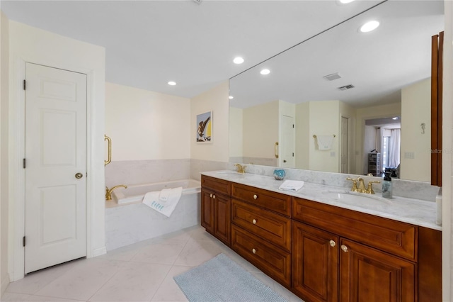 bathroom with vanity, tile patterned flooring, and a bathtub