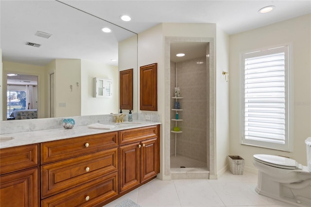 bathroom with vanity, a wealth of natural light, and toilet