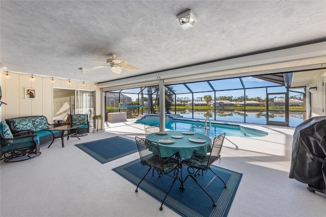 view of pool with a water view, grilling area, and ceiling fan