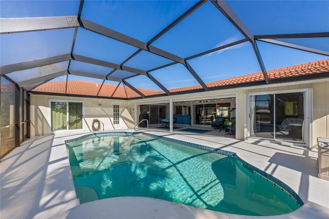 view of swimming pool featuring a lanai and a patio