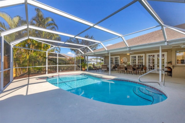 view of swimming pool featuring a lanai, a patio, ceiling fan, and french doors