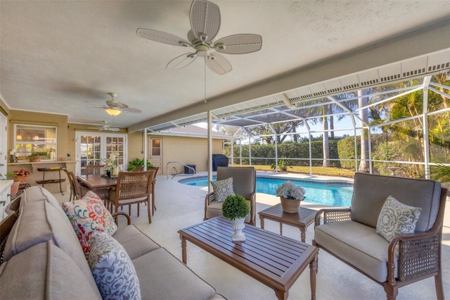 sunroom featuring a pool and ceiling fan