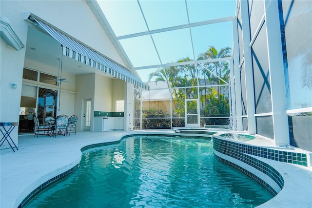 view of swimming pool with an in ground hot tub, a lanai, and a patio area