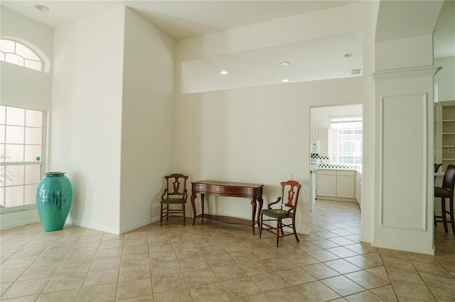 living area with light tile patterned floors and a healthy amount of sunlight