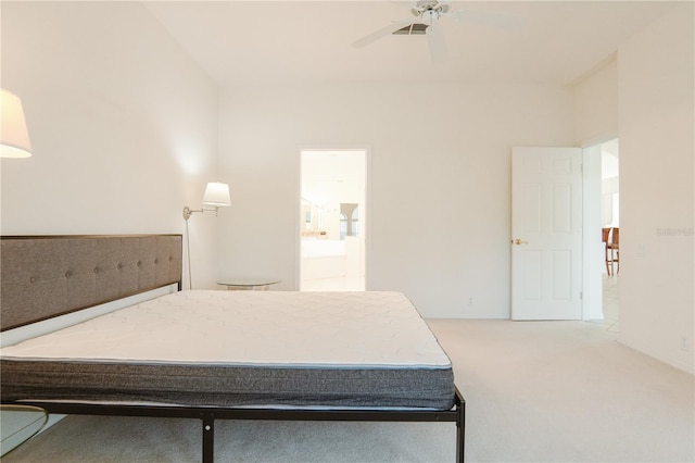 carpeted bedroom with ceiling fan and ensuite bathroom